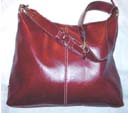 Fashion accessory factory exchange agent. Faux leather handbag in maroon with adjustable shoulder strap